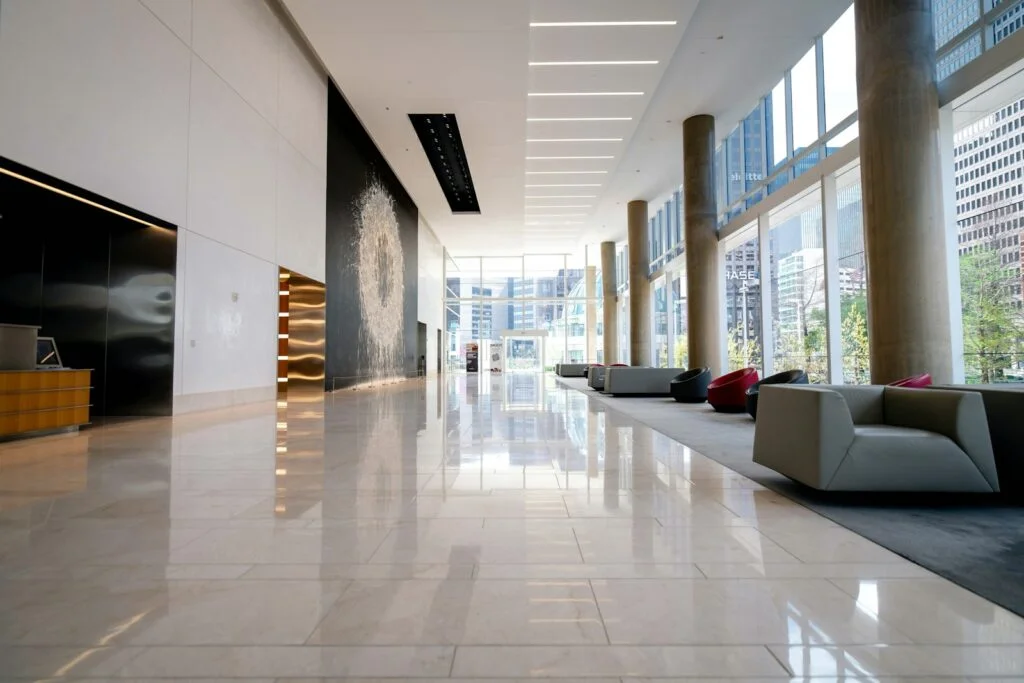 Cleaner scrubbing bathroom tile and fixtures during detailed whole-home deep cleaning visit